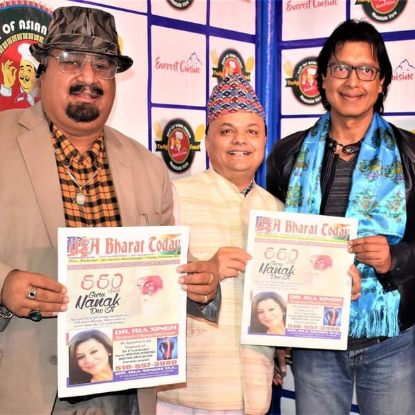 Three men holding copies of "USA Bharat Today" newspaper, standing in front of an Everest Cuisine banner.